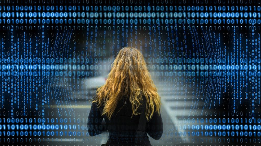 Woman in front of binary code data privacy