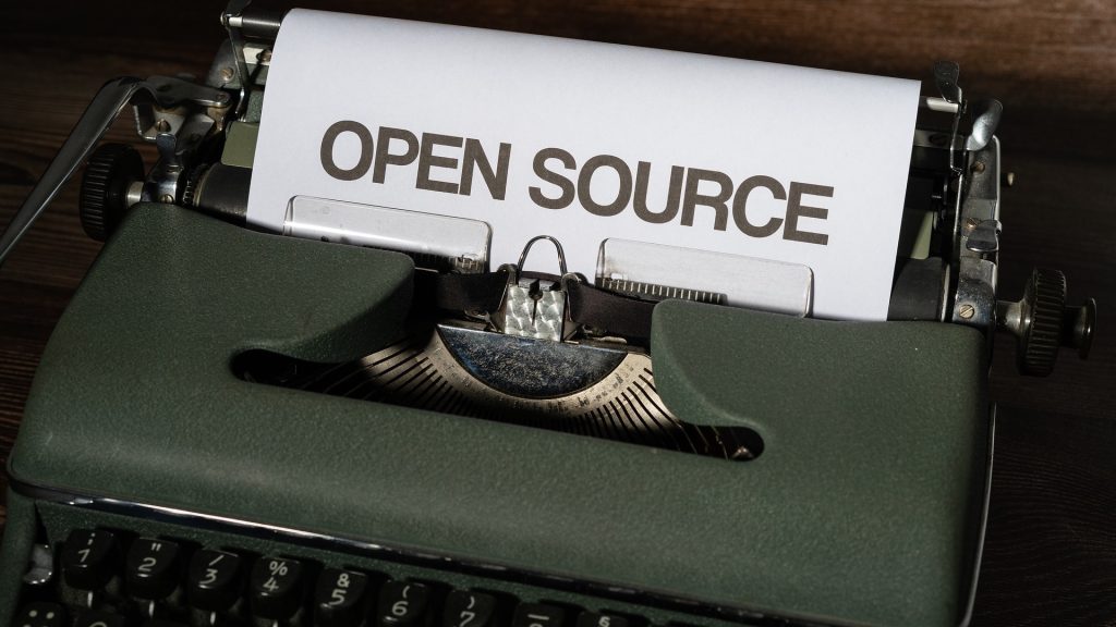 Text "Open Source" in an old-school typewriter