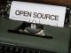 Text "Open Source" in an old-school typewriter