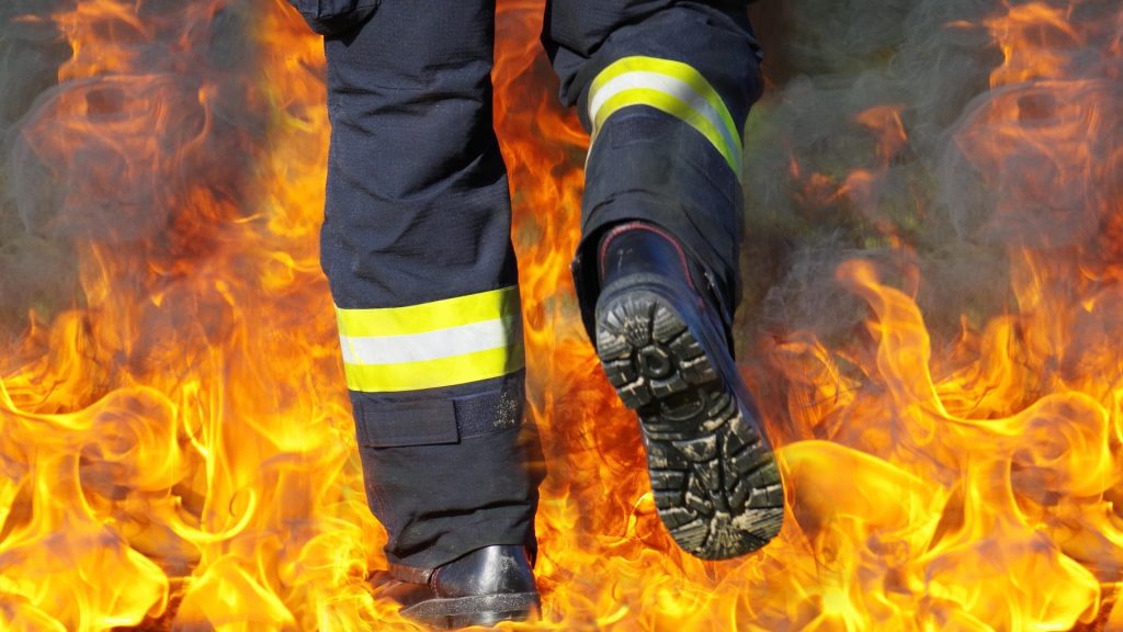 Firefighter's boots running into flames